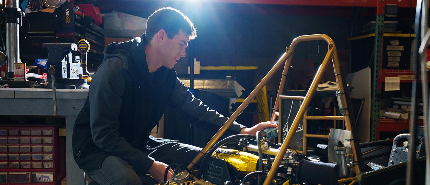 A young man working on mechanical equipment